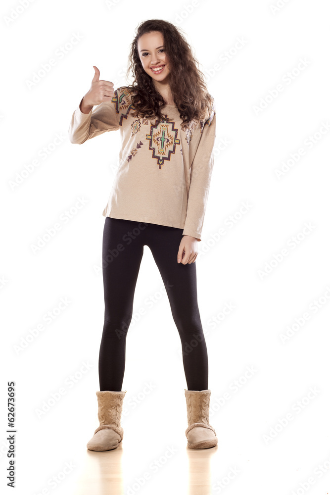 girl standing on white background and showing thumbs up girl standing on white background and showing thumbs up