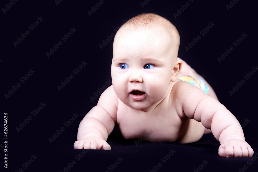 Four months baby on the dark background