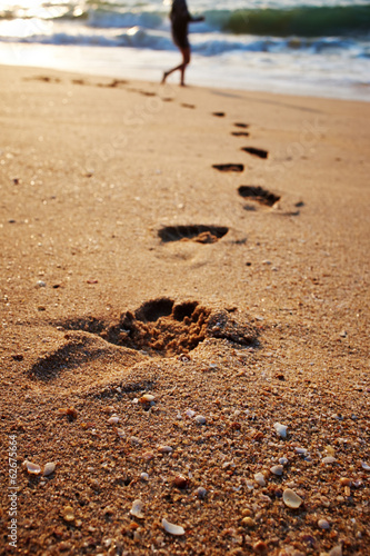 Footprints on the beach sand.Traces on the beach. Footsteps on t