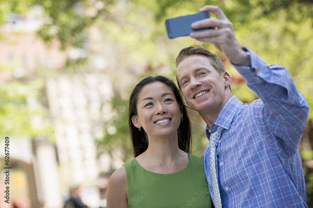 A Couple, A Man And Woman Taking A Selfy With A Smart Phone. A Couple, A Man And Woman Taking A Selfy With A Smart Phone.