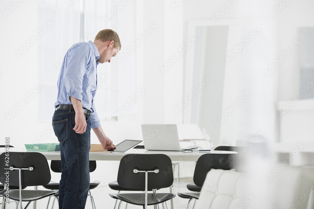 Business. A Man Checking Something On His Desk. Business. A Man Checking Something On His Desk.
