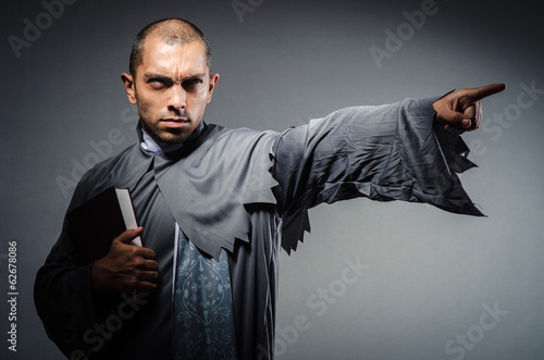 Young priest isolated on the white