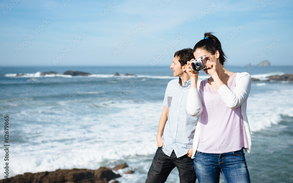 Couple on travel taking photo to beautiful seascape