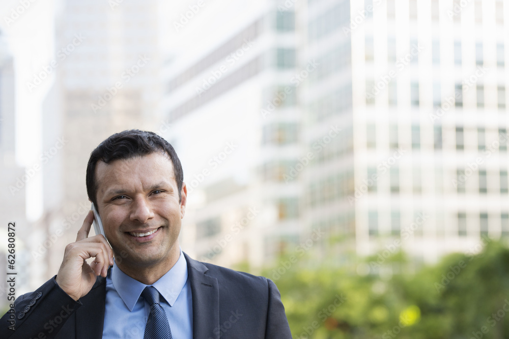 Business People. A Latino Businessman In Business Clothes. Using His Phone. Business People. A Latino Businessman In Business Clothes. Using His Phone.