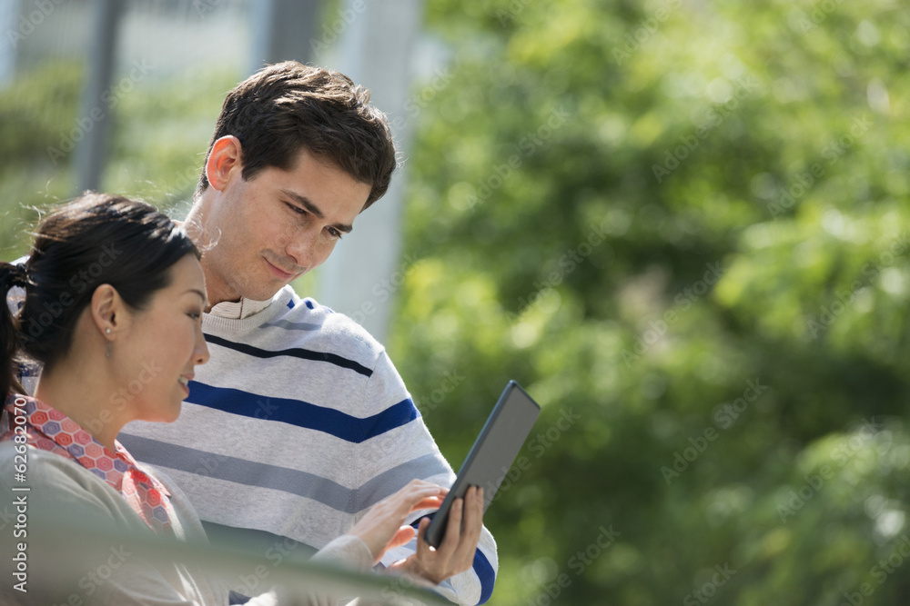 Summer. Business People. A Man And Woman Using A Digital Tablet, Keeping In Touch. 