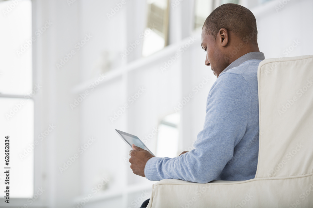 Office Life. A Man Sitting Using A Digital Tablet. Office Life. A Man Sitting Using A Digital Tablet.