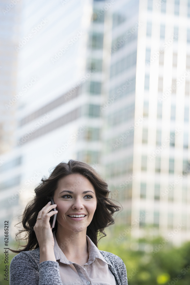 Business People. A Businesswoman In A Light Grey Jacket, Using Her Smart Phone. Business People. A Businesswoman In A Light Grey Jacket, Using Her Smart Phone.