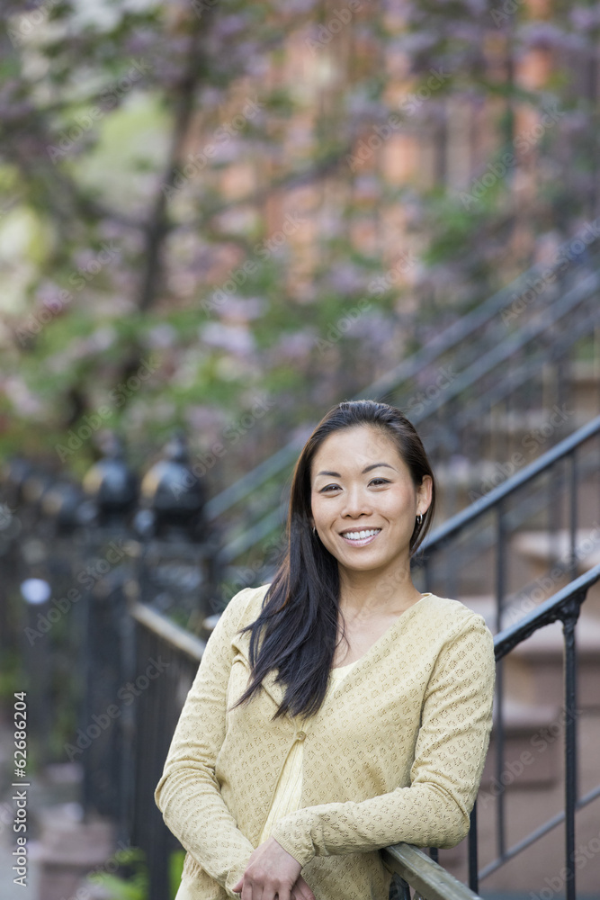 A Young Woman With Long Black Hair, Leaning On A Railing At The Bottom Of A Flight Of Steps. A Young Woman With Long Black Hair, Leaning On A Railing At The Bottom Of A Flight Of Steps.