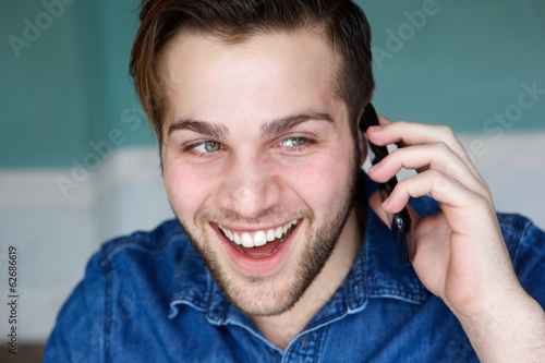 Attractive young man talking on phone