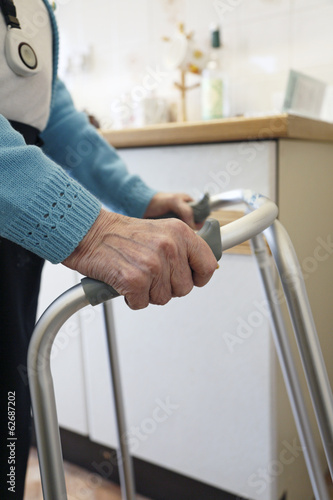 Old lady using a walking frame.