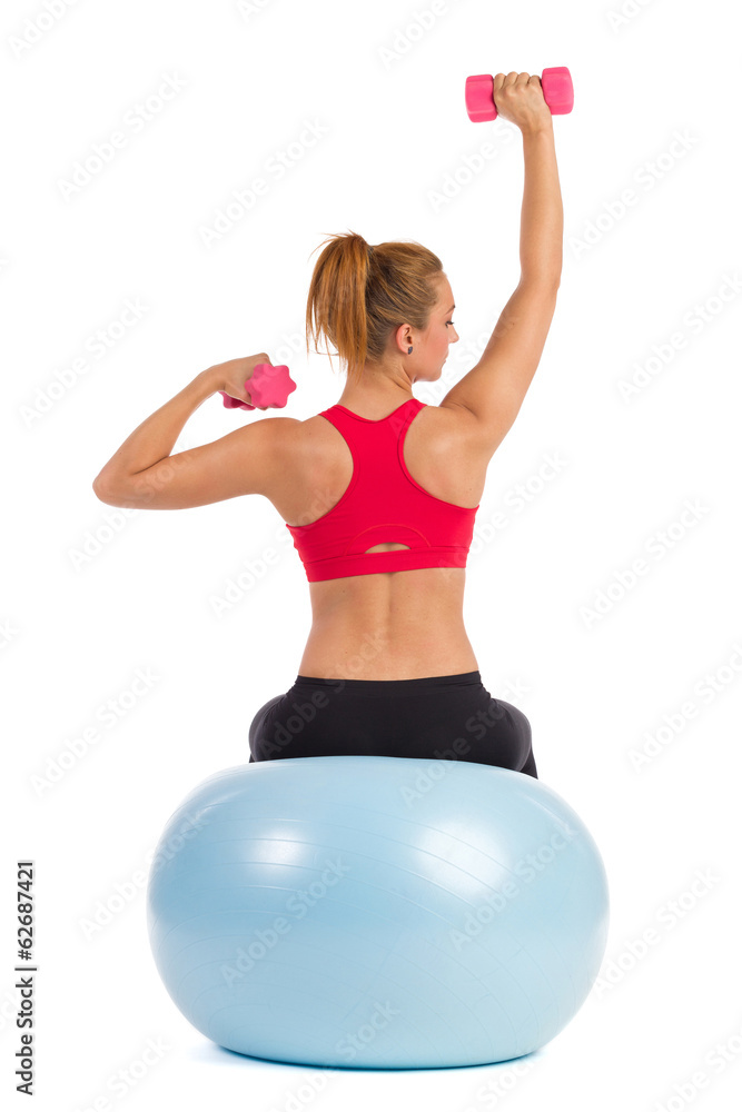 Female Exercise On Fitness Ball With Hand Weights Female Exercise On Fitness Ball With Hand Weights