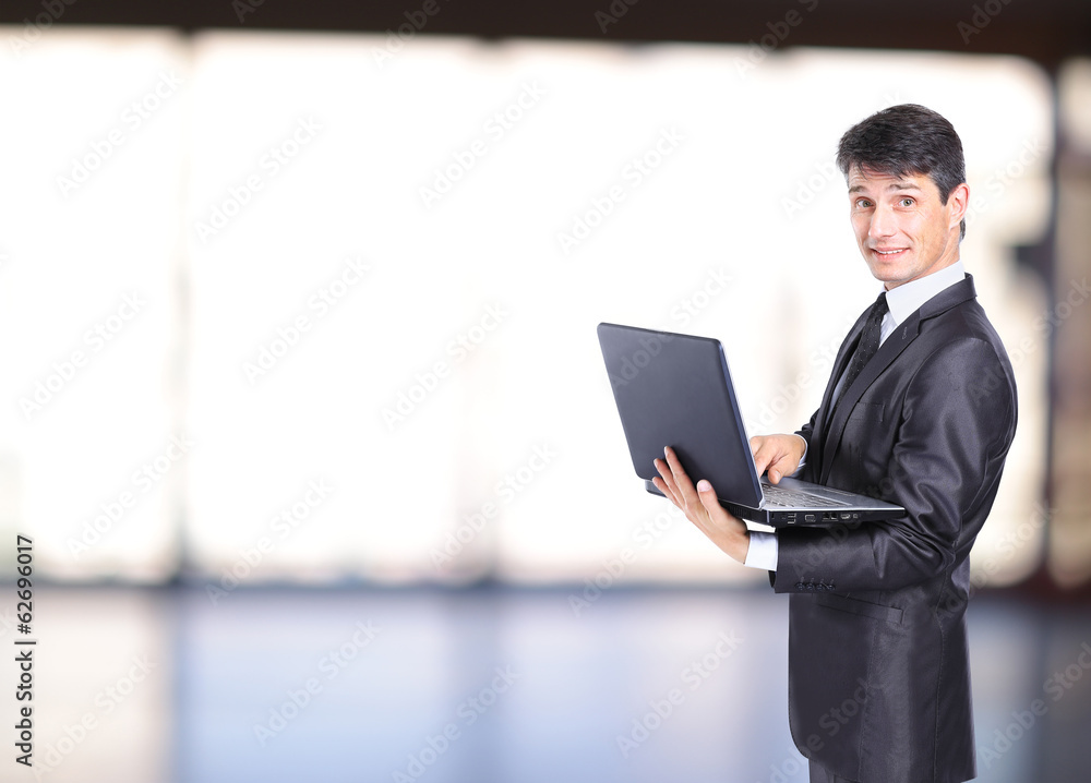 Portrait of businessman in front of laptop computer Portrait of businessman in front of laptop computer