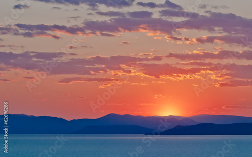 Red Clouds Sunset on blue Pacific Ocean coast