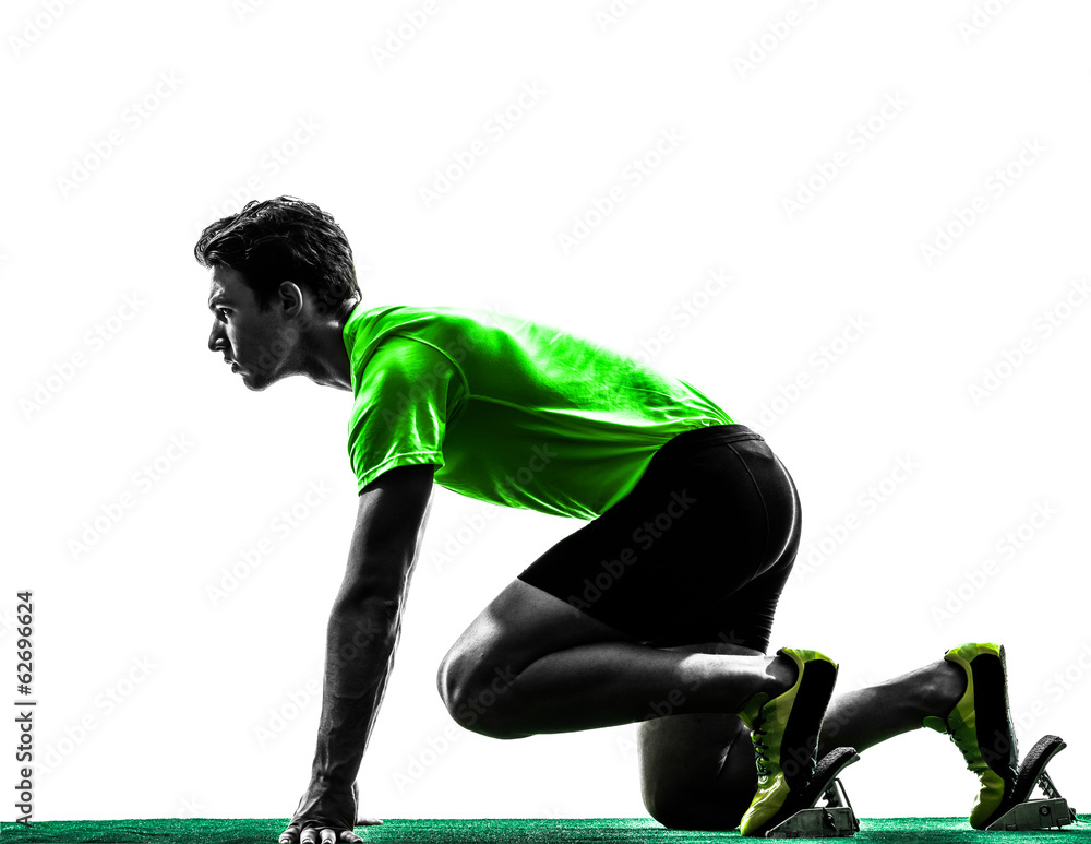 young man sprinter runner in starting blocks silhouette Stock