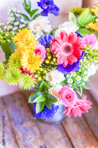 Fototapeta Naklejka Na Ścianę i Meble -  Colorful bouquet of spring flowers in vintage vase on rustic woo
