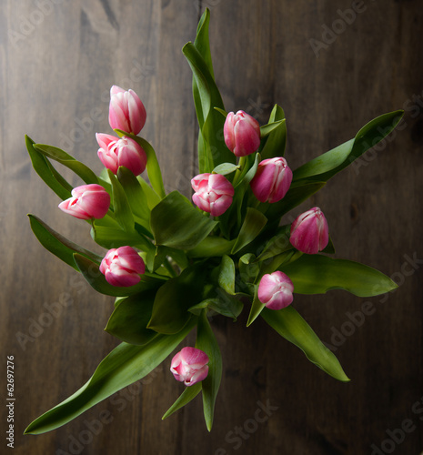 Fototapeta Naklejka Na Ścianę i Meble -  Tulips with some water splash on a wood table