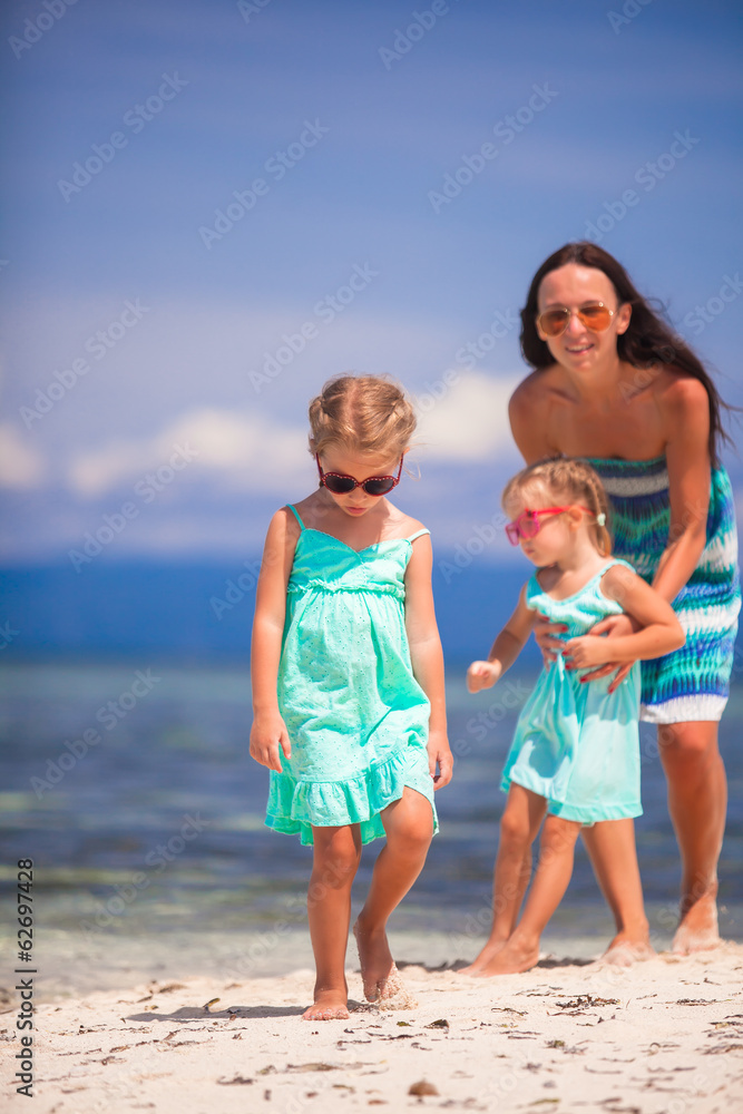 Young mother and two her daughters have fun at exotic beach on Young mother and two her daughters have fun at exotic beach on