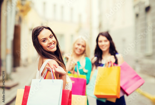 girls with shopping bags in city