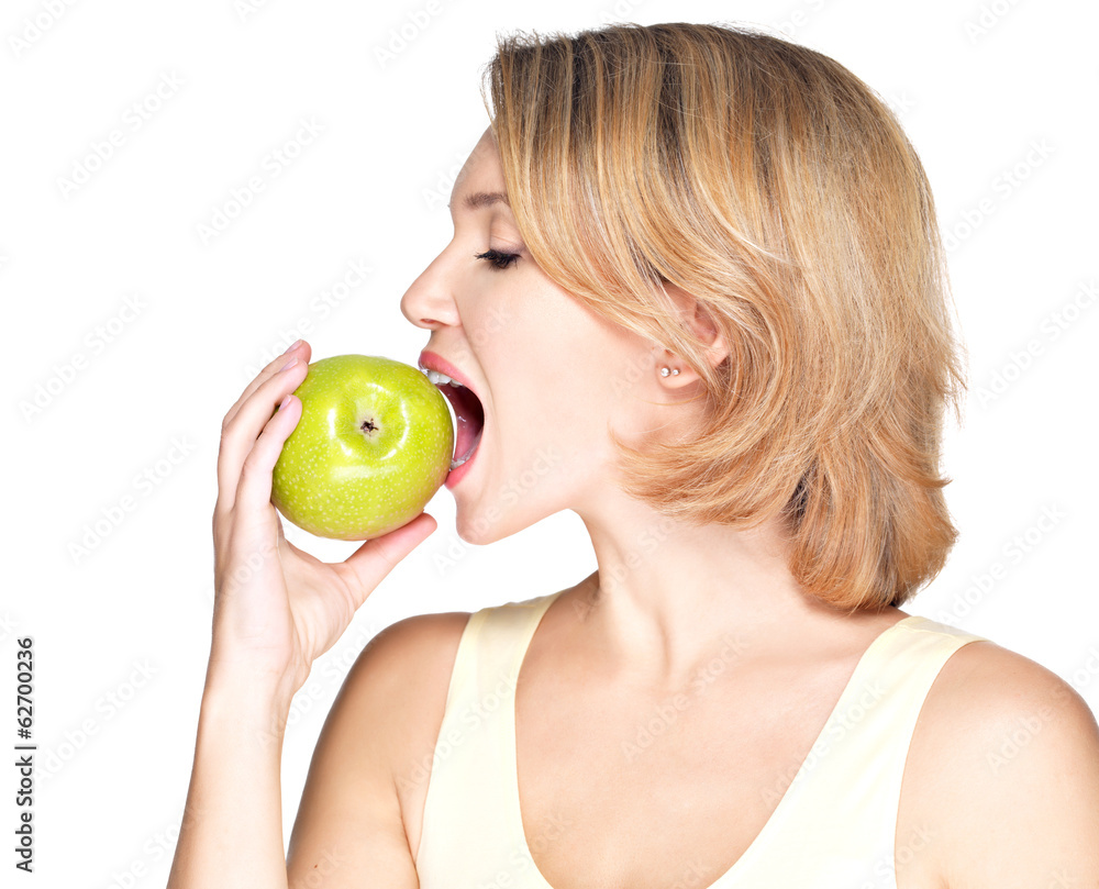 Beautiful young woman biting the biting a fresh ripe apple Beautiful young woman biting the biting a fresh ripe apple