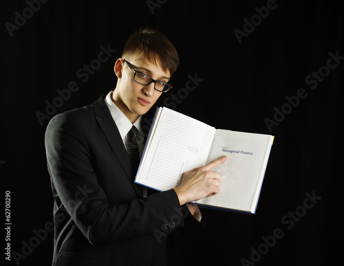 Young caucasian man holding finance book photo