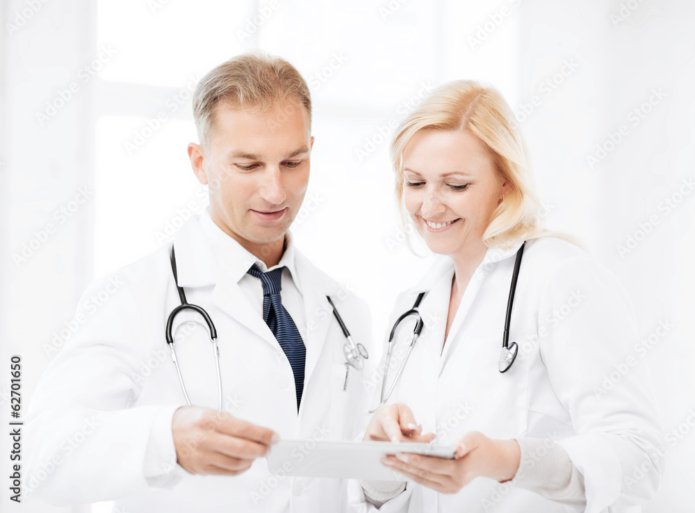 two doctors looking at tablet pc two doctors looking at tablet pc