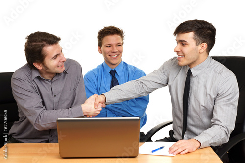 Young business people shaking hands, finishing up a meeting