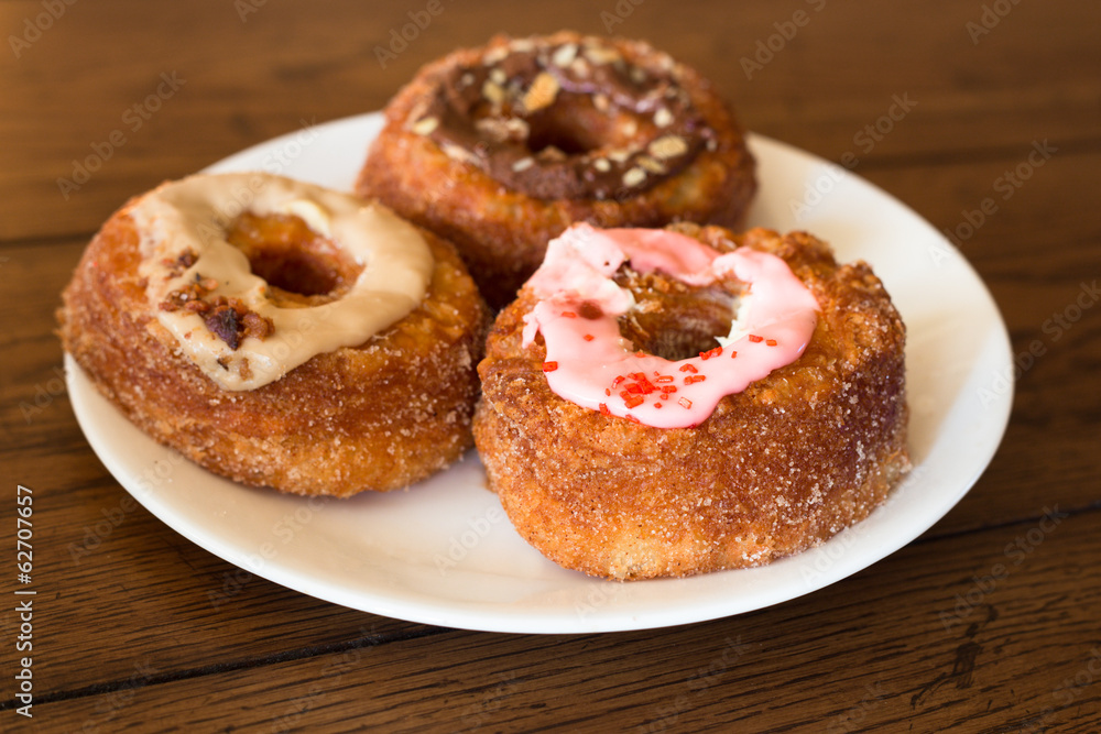Assorted cronut style donuts on plate Assorted cronut style donuts on plate