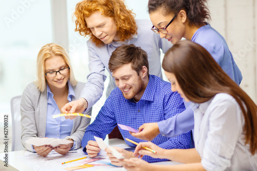 smiling team with color samples at office