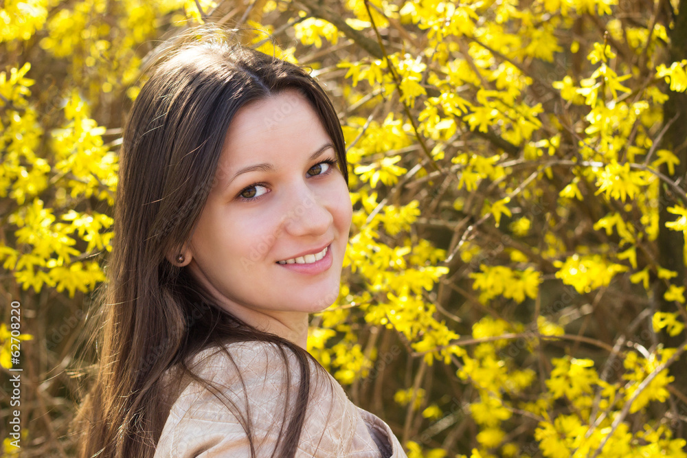 Cheerful young woman surrounded by flowers Cheerful young woman surrounded by flowers