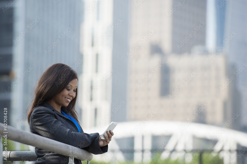 Summer. A Woman In A Grey Suit Using A Smart Phone. Summer. A Woman In A Grey Suit Using A Smart Phone.