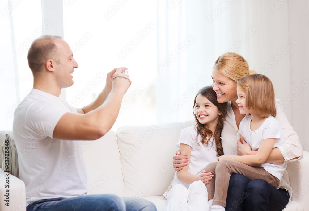 father taking picture of mother and daughters father taking picture of mother and daughters