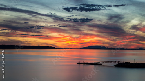 Spectacular and colorful clouds at sunset from willingdon beach in powell river, british columbia, canada.