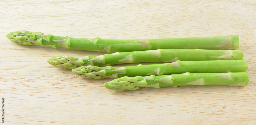 ripe green asparagus on a wooden background ripe green asparagus on a wooden background