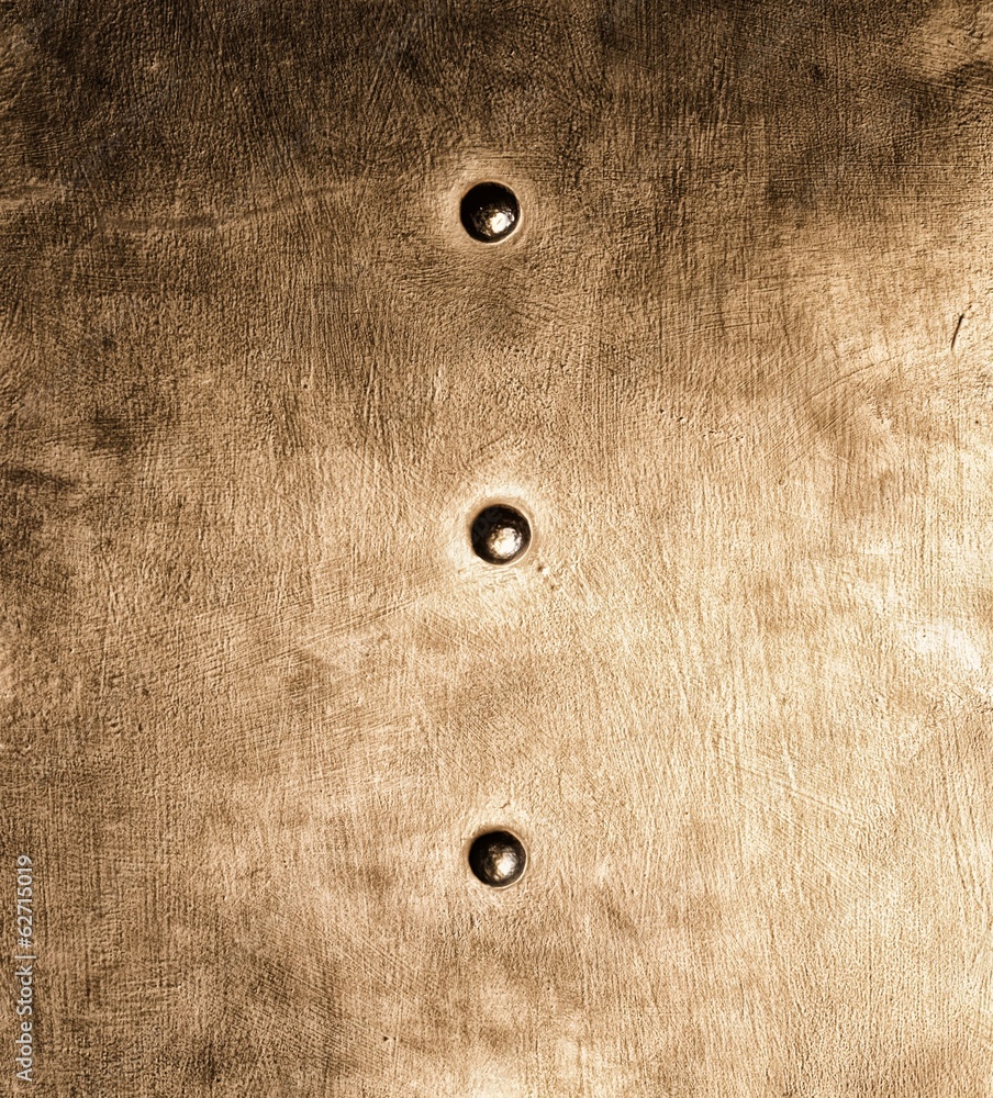 Grunge gold brown metal plate rivets screws background texture Grunge gold brown metal plate rivets screws background texture
