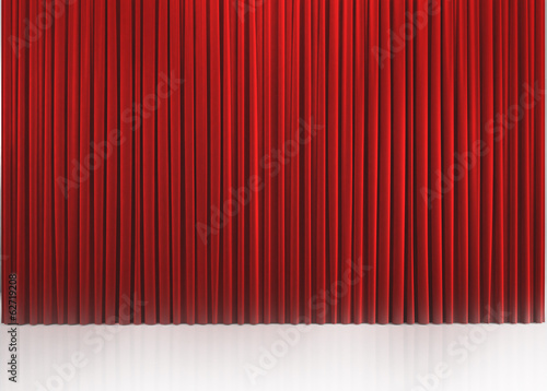 Red closed curtain with light spots in a theater
