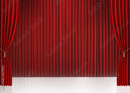 Red closed curtain with light spots in a theater