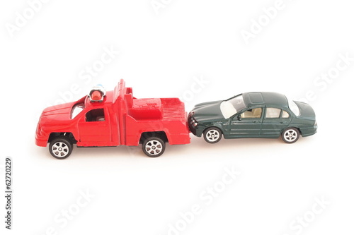 toy police truck pulling car on white background