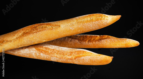 Baguette bread isolated on black background