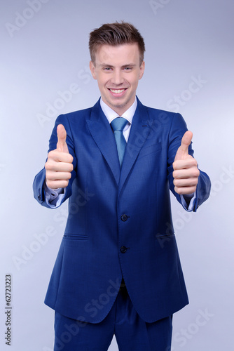 Business man on grey backgr...