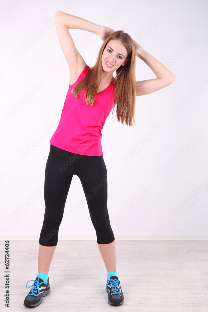 Young beautiful fitness girl exercising in gym Young beautiful fitness girl exercising in gym