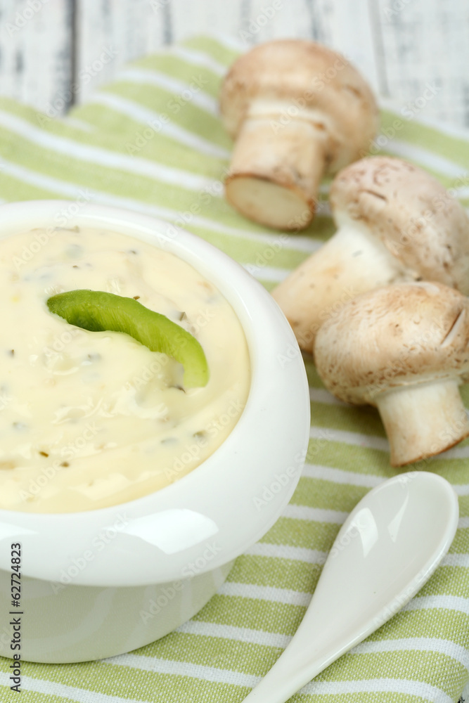 Delicate mushroom sauce in bowl on wooden table close-up Delicate mushroom sauce in bowl on wooden table close-up