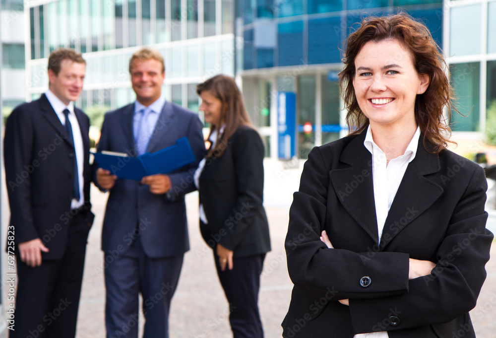 Group of business people with businesswoman leader on foreground Group of business people with businesswoman leader on foreground
