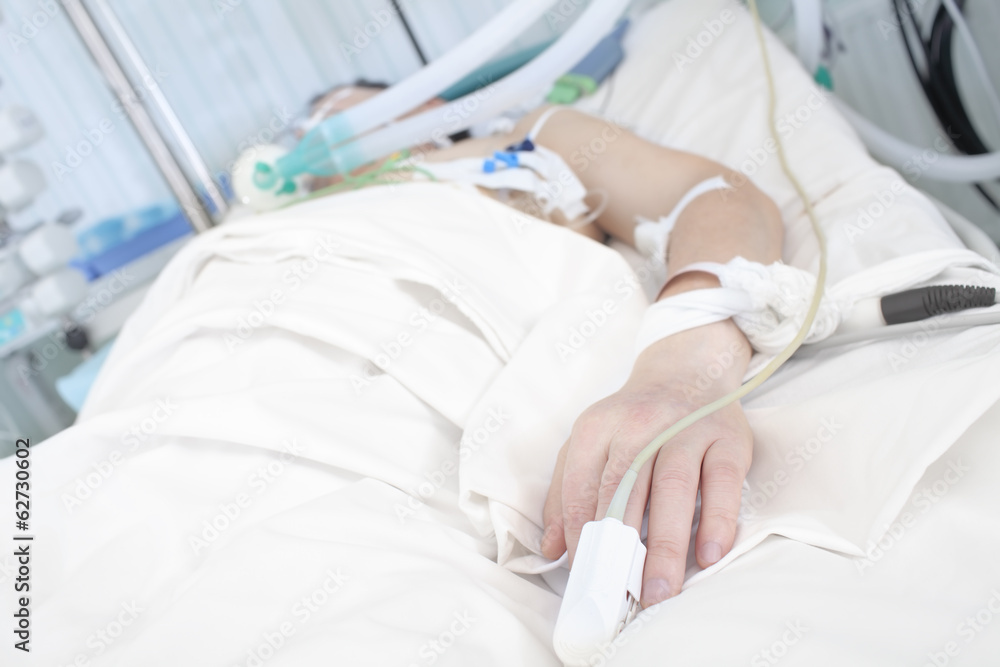 Patient in bed. Hand in focus Patient in bed. Hand in focus