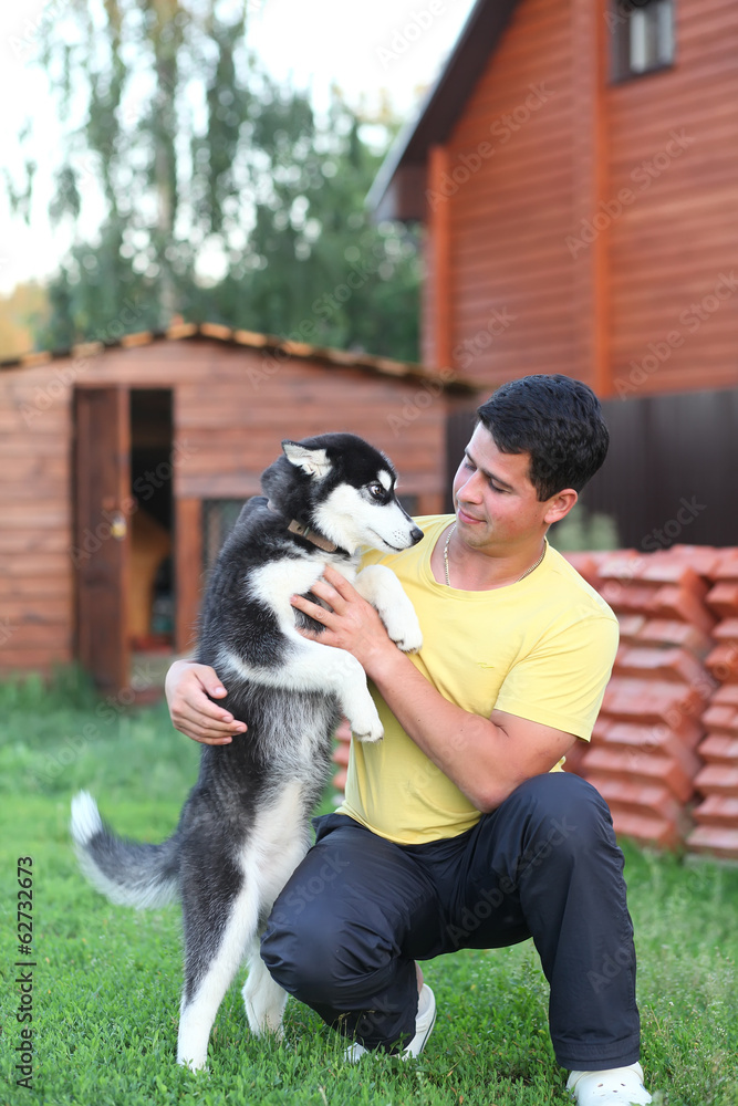 young man and his husky dog outdoors young man and his husky dog outdoors