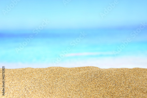 Close up of golden sand with sea on the background