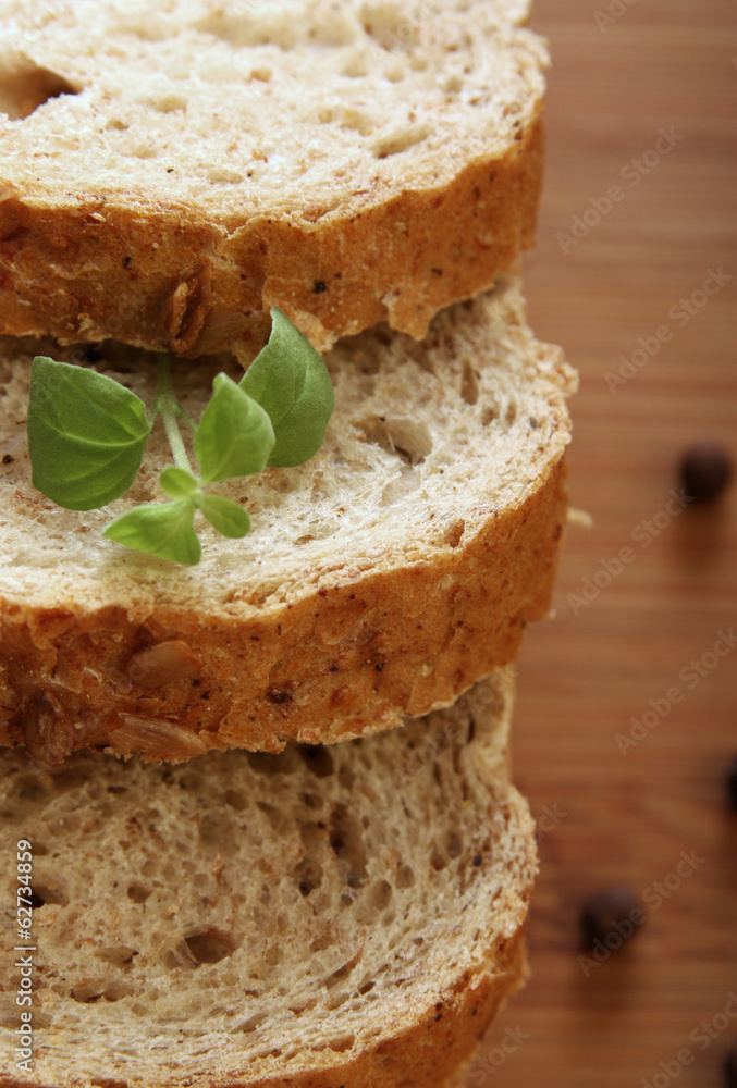Sliced of whole bread on a wooden desk Sliced of whole bread on a wooden desk
