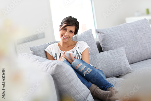 Young woman sending text message with smartphone