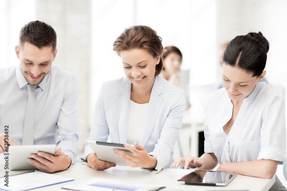 business team working with tablet pcs in office business team working with tablet pcs in office