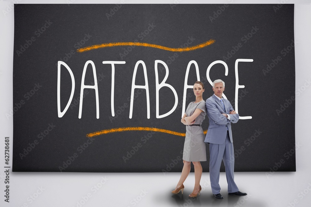 Business people standing against the word database Business people standing against the word database