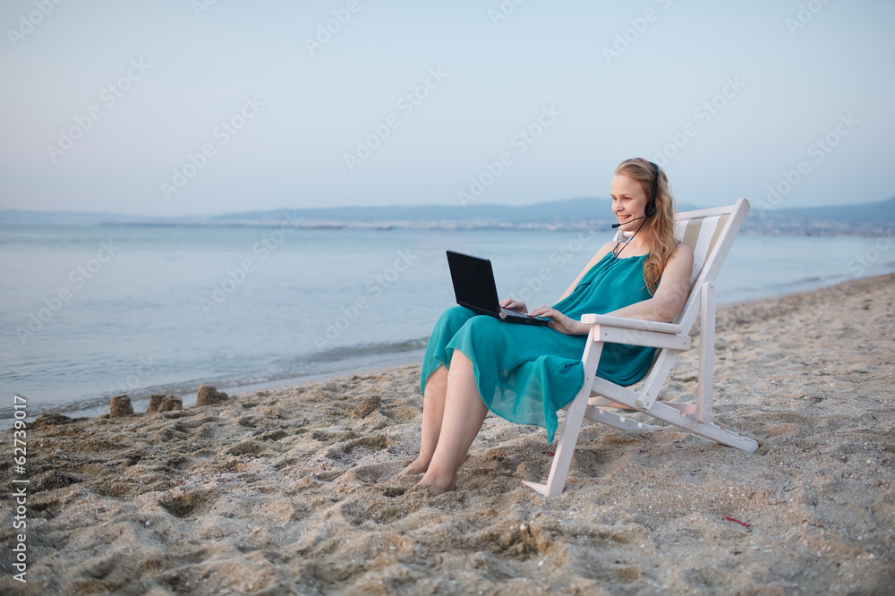 Woman talking skype at the beach
